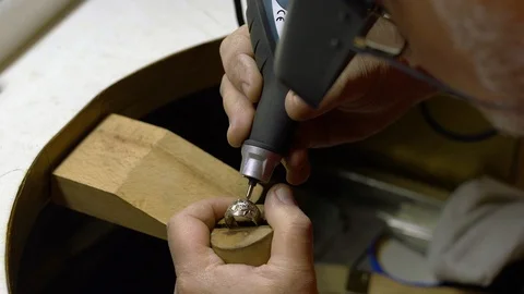 Jeweler in the workshop engraves the ring Stock Footage 108342603