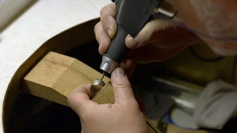 Jeweler in the workshop engraves the ring 스톡 동영상 108342607