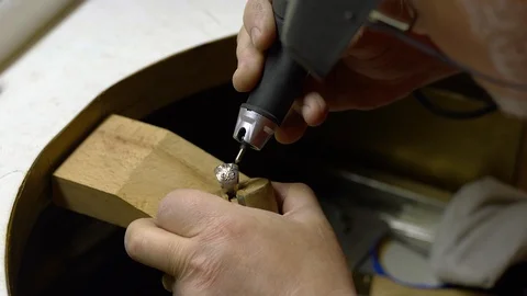 Jeweler in the workshop engraves the ring Stock Footage 108342640