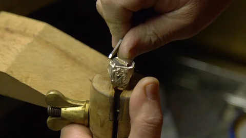 Jeweler in the workshop engraves the ring Stock Footage 108342747