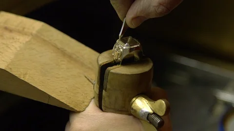 Jeweler in the workshop engraves the ring Stock Footage 108342766