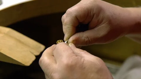 Jeweler in the workshop engraves the ring Stock Footage 108342875