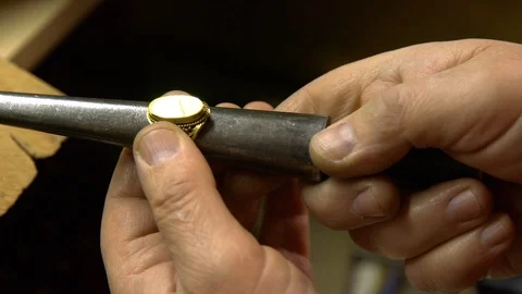 Jeweler in the workshop increases the size of the ring Stock Footage 108343719