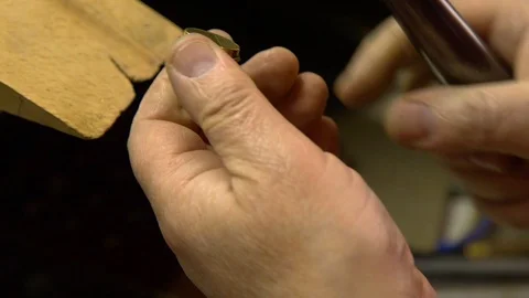 Jeweler in the workshop increases the size of the ring Stock Footage 108343724