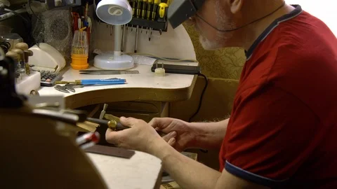 Jeweler in the workshop increases the size of the ring Stock Footage 108343760