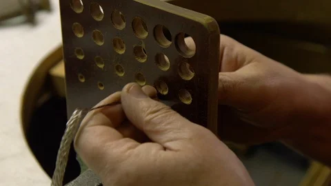 Jeweler in the workshop pulls the chain through the fellier Stock Footage 108343308