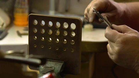 Jeweler in the workshop pulls the chain through the fellier Stock Footage 108343359