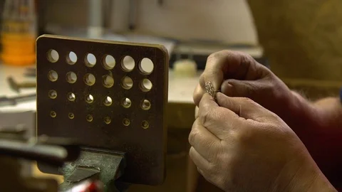 Jeweler in the workshop pulls the chain through the fellier Stock Footage 108343422