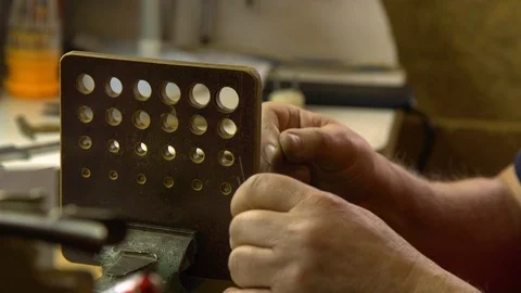 Jeweler in the workshop pulls the chain through the fellier Stock Footage 108343480