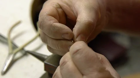 The jeweler in the workshop repairs the chain lock Stock Footage 108342964