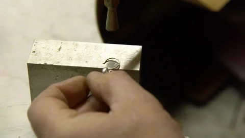 Jeweler in the workshop repairs an earring Stock Footage 108343103