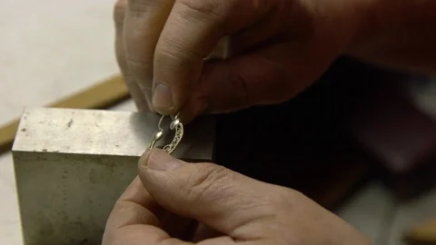 Jeweler in the workshop repairs an earring Stock Footage 108343150
