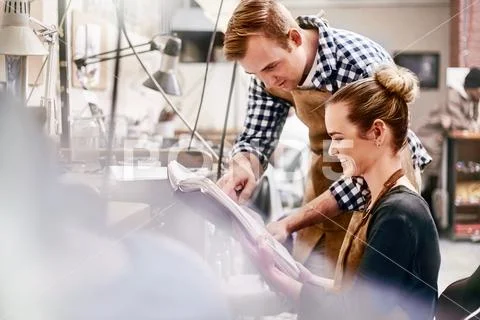 Jewelers reviewing plans in workshop Stock Photos