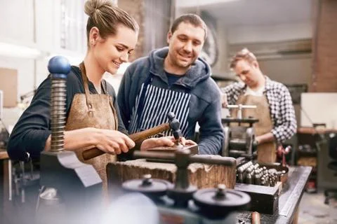 Jewelers using equipment in workshop Stock Photos