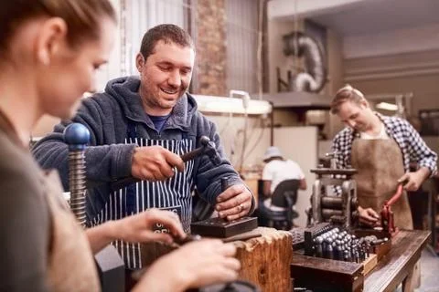 Jewelers using equipment in workshop Stock Photos