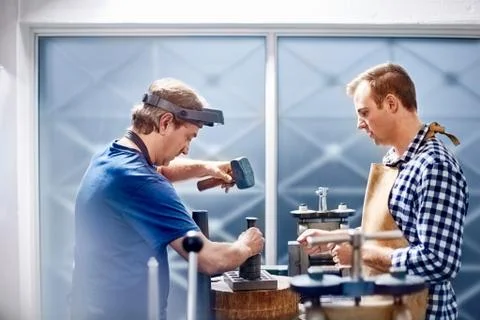 Jewelers using equipment in workshop Stock Photos
