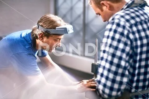 Jewelers using equipment in workshop Stock Photos