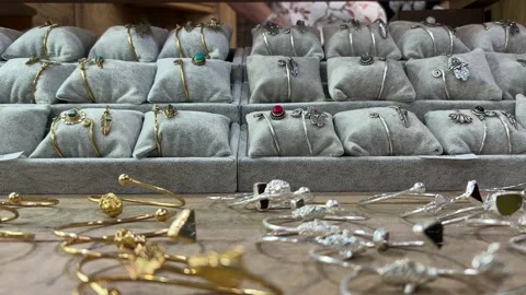 Jewelry and bangles all on display on a table Stock Footage 235420579