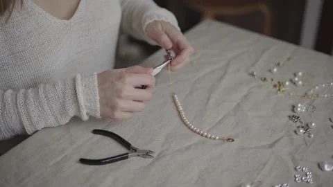 Jewelry designer working in studio making pearl bracelet Stock Footage 132060162