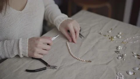 Jewelry designer working in studio making pearl bracelet Stock Footage 132060524