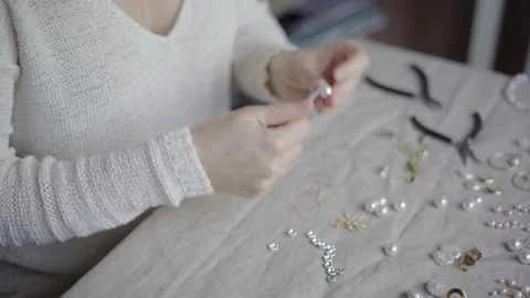 Jewelry designer working in studio with tools, materials and jewelry items Stock Footage 132053734