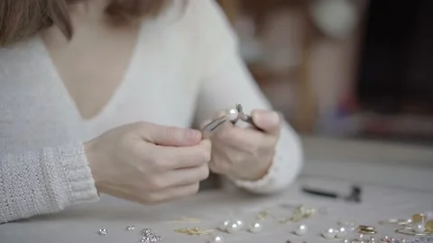 Jewelry designer working in studio with tools, materials and jewelry items Stock Footage 132055212