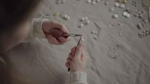 Jewelry designer working in studio with tools making jewelry items with pearl Stock Footage 132055279