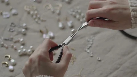 Jewelry designer working in studio with tools making jewelry items with pearl Stock Footage 132055709