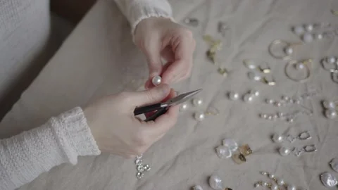 Jewelry designer working in studio with tools making jewelry items with pearl Stock Footage 132056009