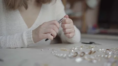 Jewelry designer working in studio with tools making jewelry items with pearl Stock Footage 132056205