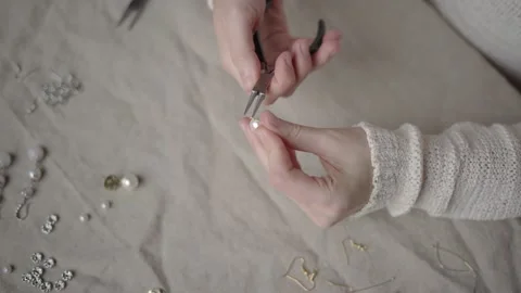 Jewelry designer working in studio with tools making jewelry items with pearl Stock Footage 132056424