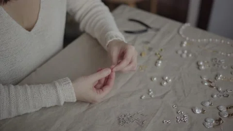 Jewelry designer working in studio with tools making jewelry items with pearl Stock Footage 132056597