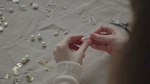 Jewelry designer working in studio with tools making jewelry items with pearl Stock Footage 132056651