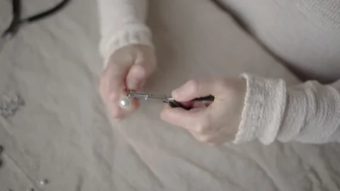 Jewelry designer working in studio with tools making jewelry items with pearl Stock Footage 132056832