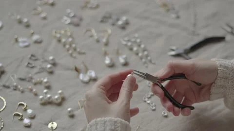 Jewelry designer working in studio with tools making jewelry items with pearl Stock Footage 132056857