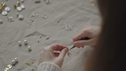 Jewelry designer working in studio with tools making jewelry items with pearl Stock Footage 132058529