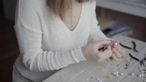 Jewelry designer working in studio with tools, materials and jewelry items Stock Footage 132060332