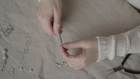 Jewelry designer working with tools making pearl earrings Stock Footage 132055970