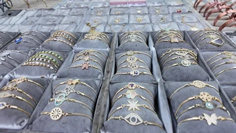 Jewelry display with various bangles and rings for sale Stock Footage 321721258