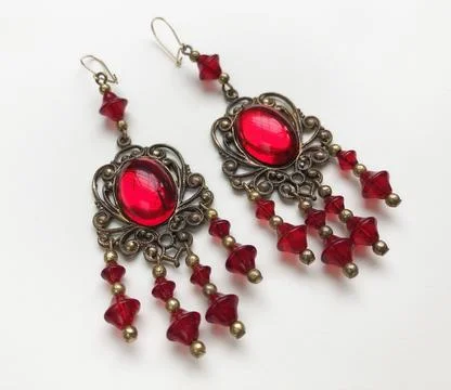 Jewelry earrings with red ruby on a white background. Stock Photos