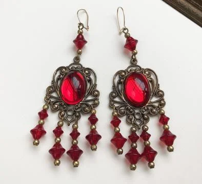 Jewelry earrings with red ruby on a white background. Stock Photos
