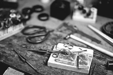 Jewelry maker workbench with tools on table. Stock Photos