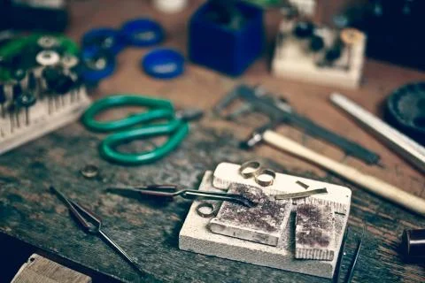 Jewelry maker workbench with tools on table Stock Photos