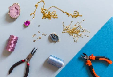 Jewelry making and beading process. Findings, pendants, geode and pliers. Mak Stock Photos