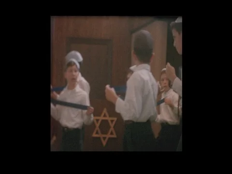 Jewish boys in play at synagogue hold Star of David Stock Footage
