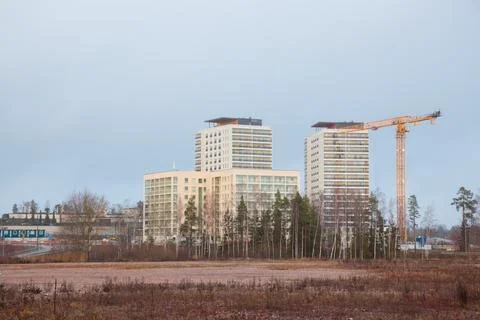 Jib construction tower crane and new residential buildings at a construction  Stock Photos