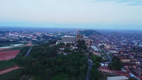 Jib down of a large luxurious hotel under construction in the city of Ibadan Stock Footage 312319618