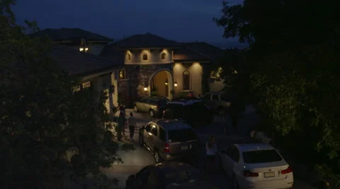 Jib Down of Teens Arriving for Party at House at Night Stock Footage 62652164