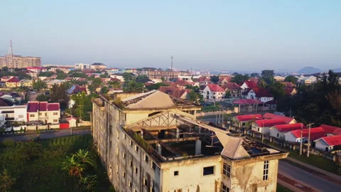 Jib up of a large ruined building with collapsed rooftops Stock Footage 320158929
