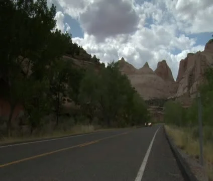 Jib shot of three motorcycles passing camera in Capitol reef national Park Stock Footage 21647853